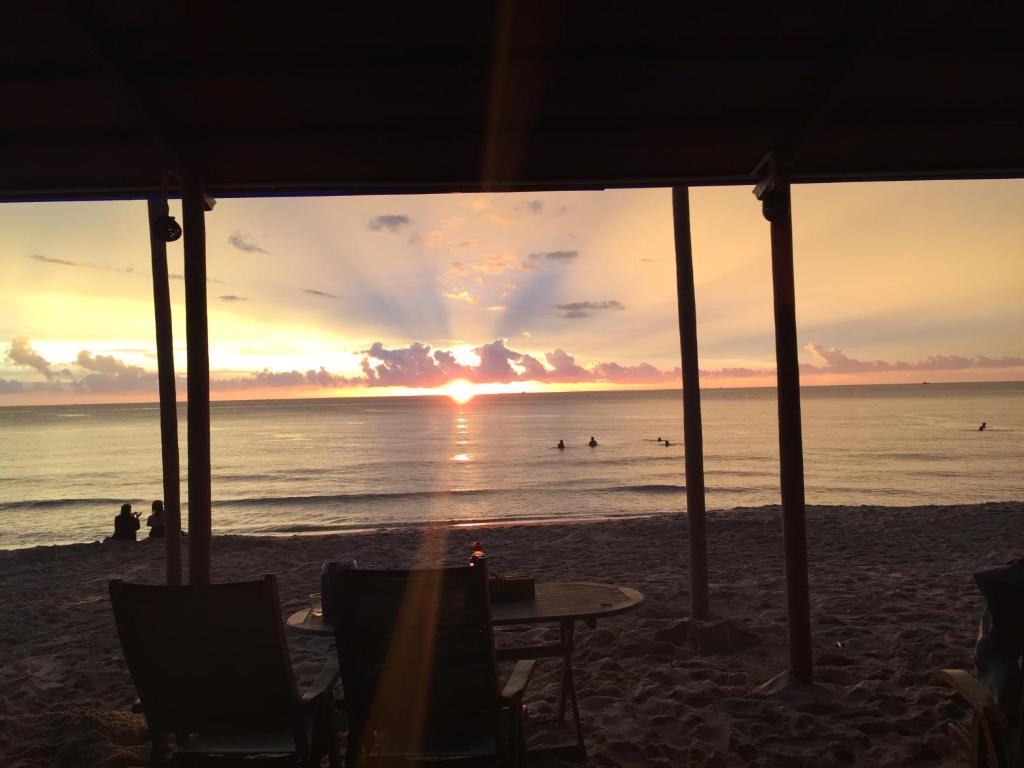 Thatched beach bar glowing at dusk